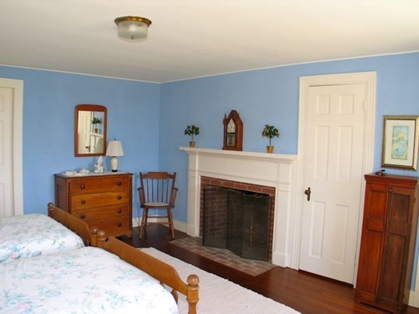 384 Middle Road Chilmark, MA 02535 - Photo 24 of 31 a bedroom with a bed and a fireplace