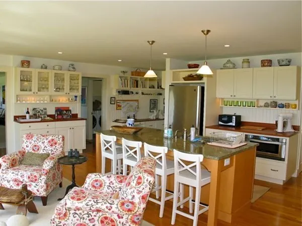 a kitchen with stainless steel appliances kitchen island granite countertop a sink and cabinets