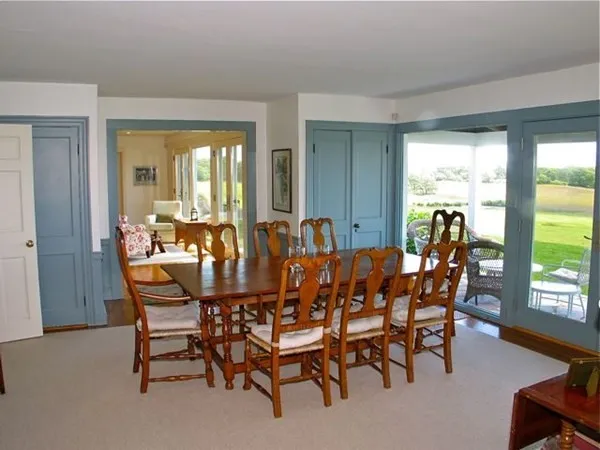 a view of a dining room with furniture and window