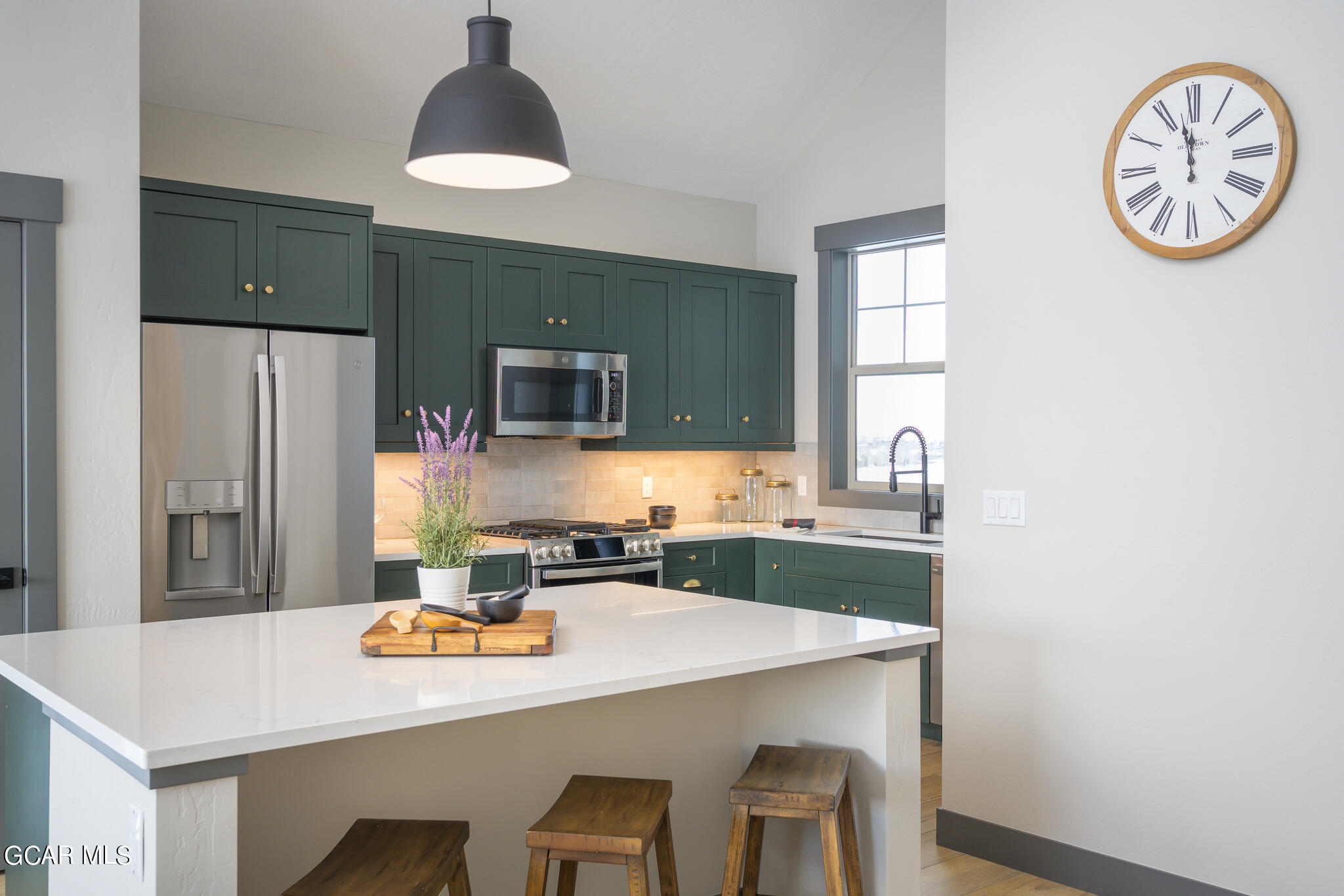 150 Eagle Ridge Drive Granby, CO 80446 - Photo 2 of 5 a kitchen with a table a stove a sink a refrigerator with a dining table and chairs