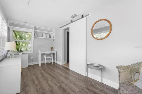 a kitchen with kitchen island white cabinets and stainless steel appliances