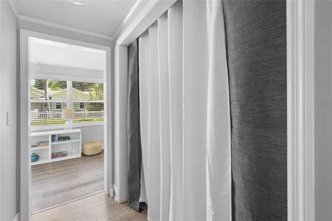 a dining room with furniture a window and wooden floor