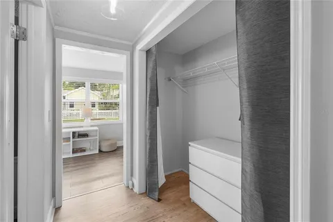 a view of a dining room with furniture and a window