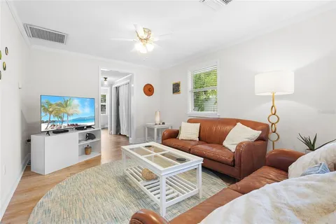 a living room with furniture and large windows