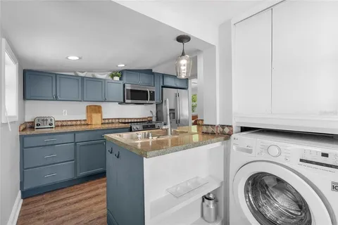 a bedroom with a bed and painting on the wall