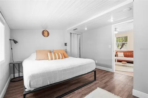 a backyard of a house with chairs and wooden fence