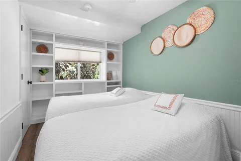 a yellow house with table and chairs in patio