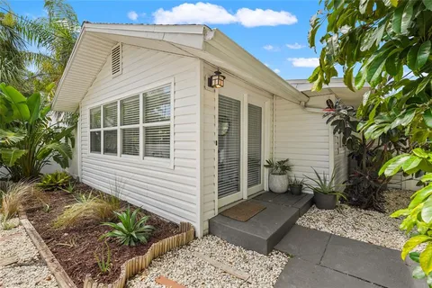 a kitchen with granite countertop a sink dishwasher a stove and a wooden cabinets with wooden floor