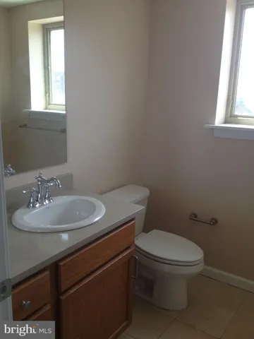 a bathroom with a toilet a sink and a window