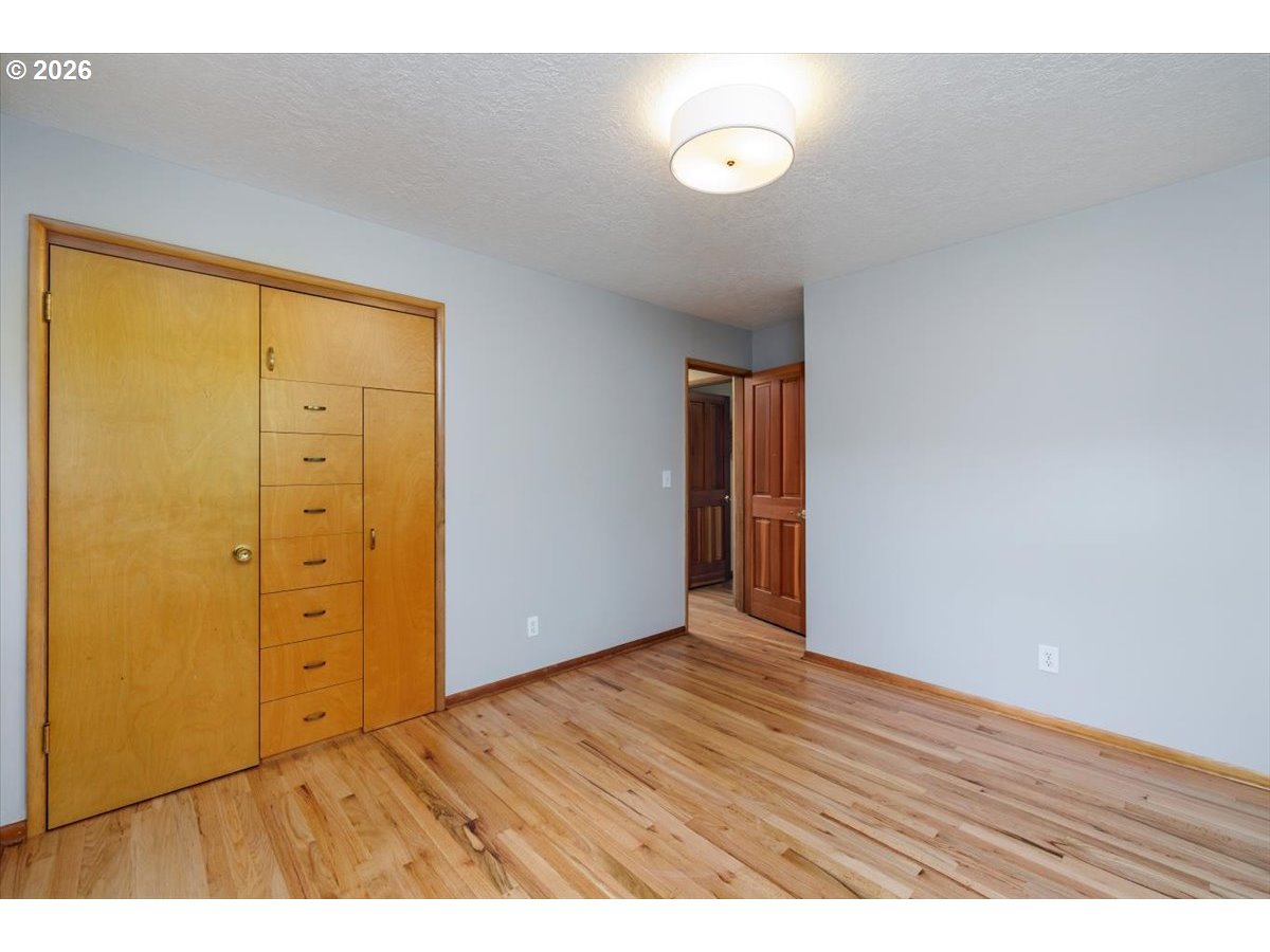 175 Northwest 95th Avenue Portland, OR 97229 - Photo 21 of 46 a view of an empty room with wooden floor and closet