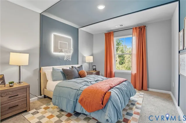 a bed sitting in a bedroom next to a window