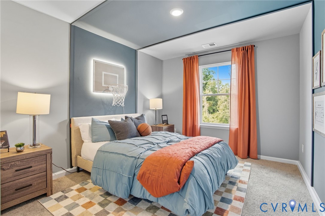 7725 Arbor Marsh Terrace New Kent, VA 23124 - Photo 19 of 27 a bed sitting in a bedroom next to a window