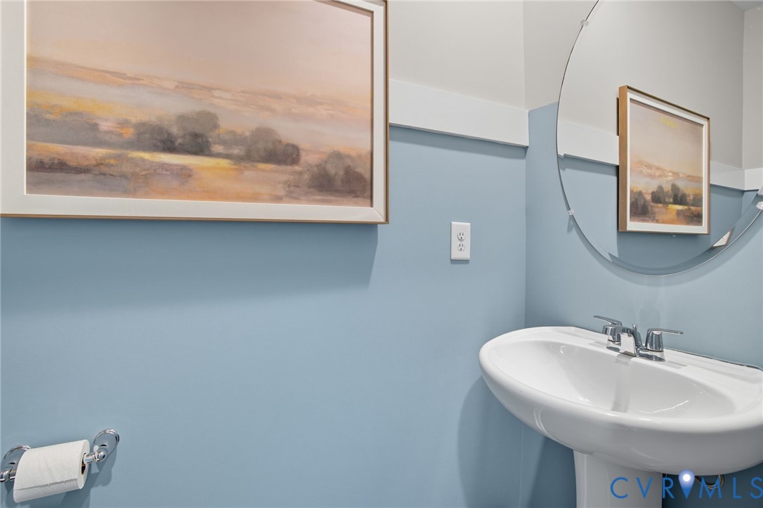 7725 Arbor Marsh Terrace New Kent, VA 23124 - Photo 26 of 27 a bathroom with a sink and mirror