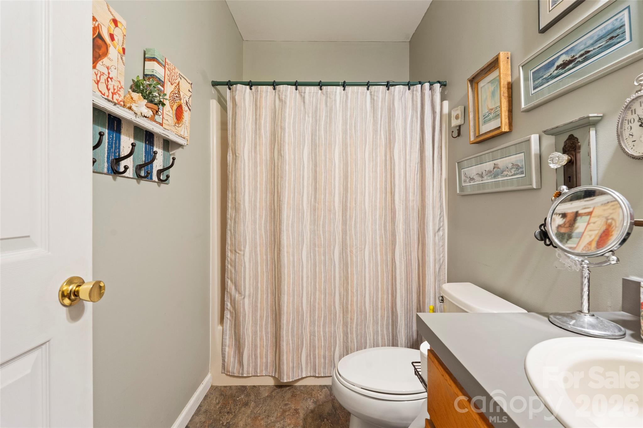319 Glenn Bridge Road, Unit 24 Arden, NC 28704 - Photo 18 of 37 a bathroom with a sink a toilet and shower curtain