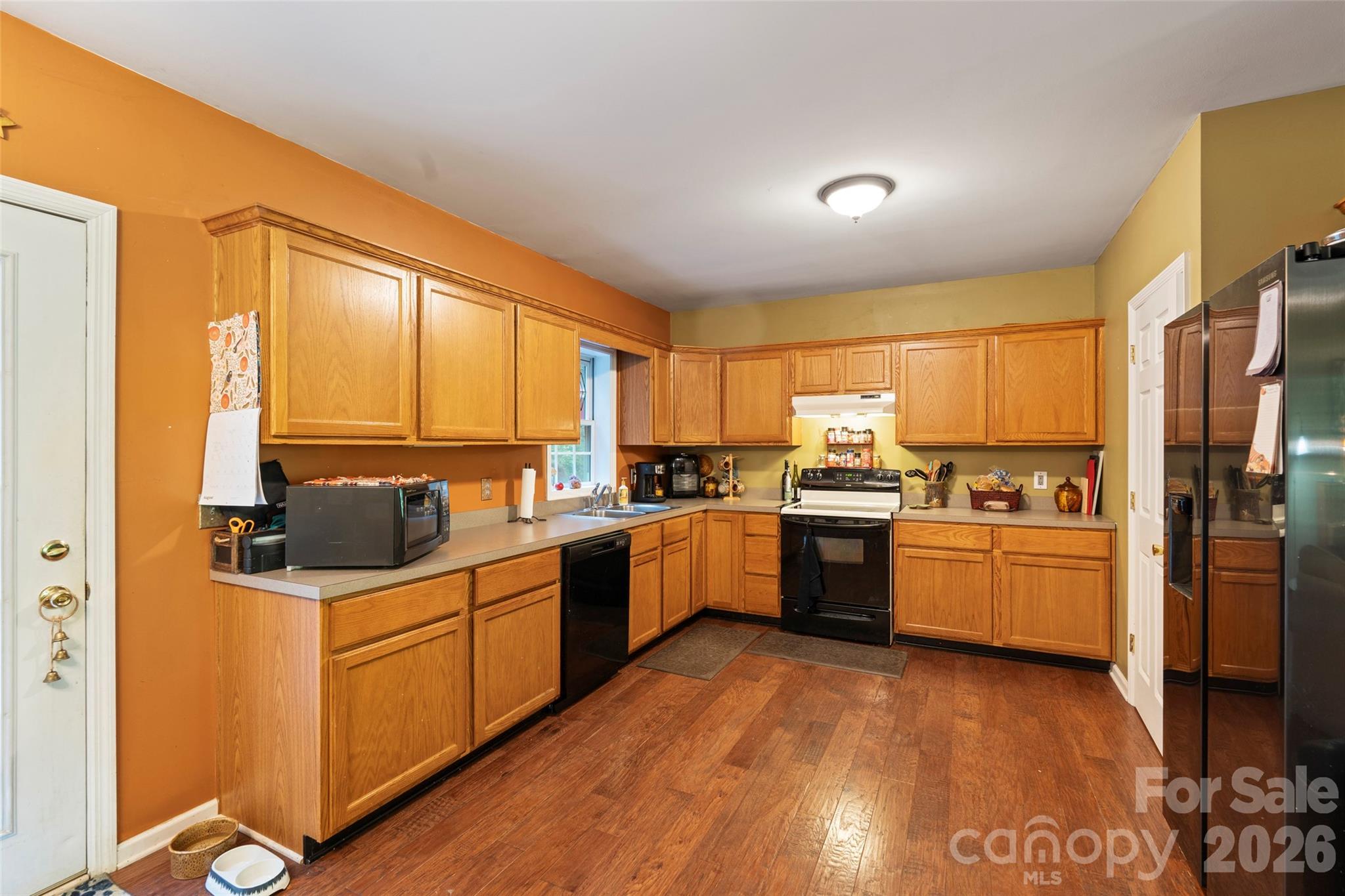 319 Glenn Bridge Road, Unit 24 Arden, NC 28704 - Photo 2 of 37 a kitchen with a sink cabinets stainless steel appliances and a window