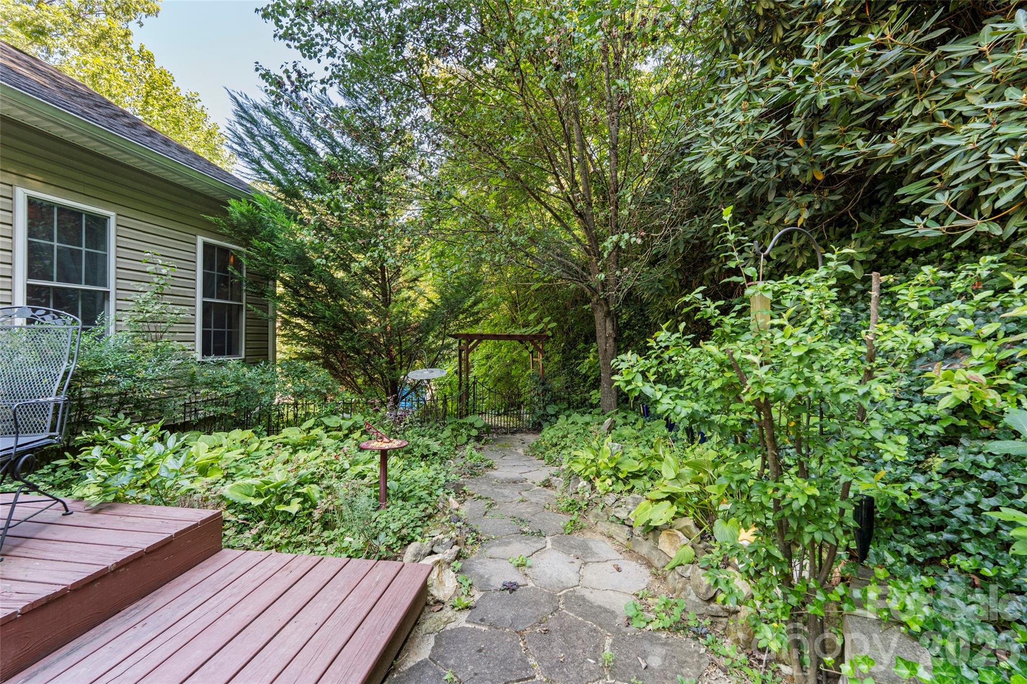 319 Glenn Bridge Road, Unit 24 Arden, NC 28704 - Photo 35 of 37 a view of a backyard with potted plants and large tree