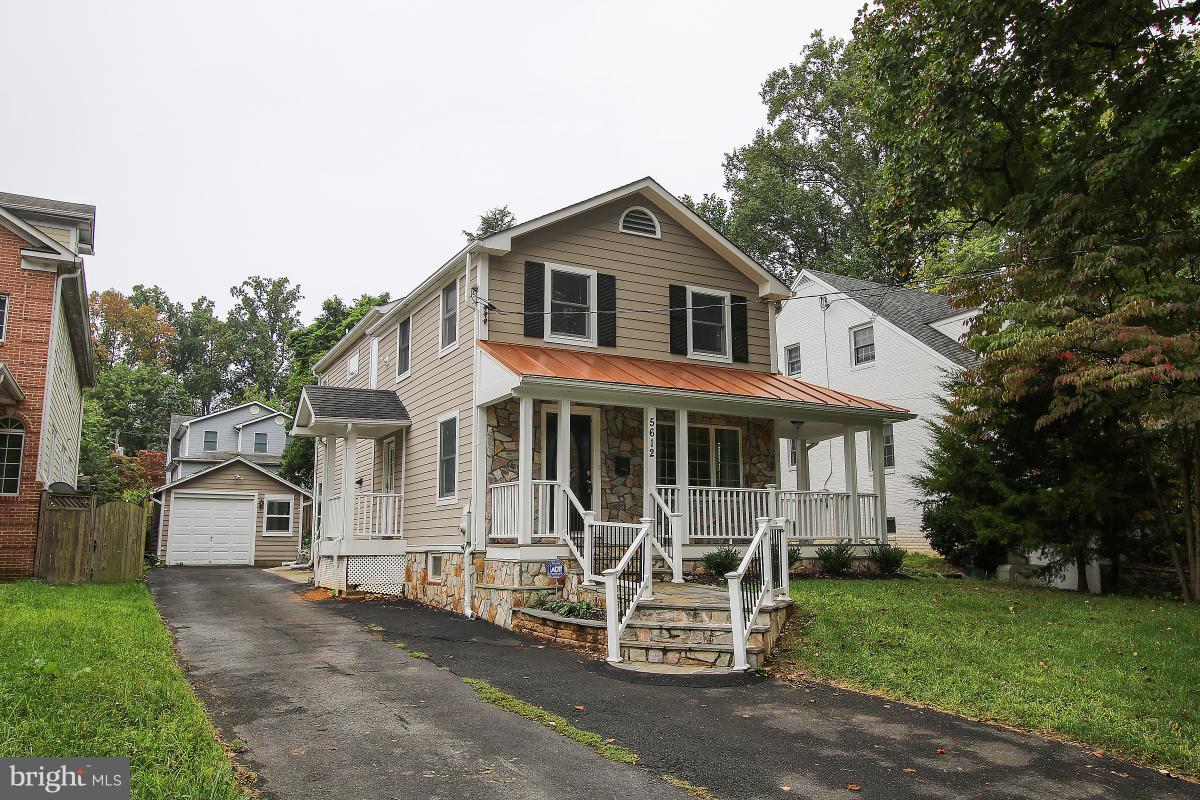 5612 Greentree Road Bethesda, MD 20817 - Photo 2 of 28 a front view of a house with a garden and chairs