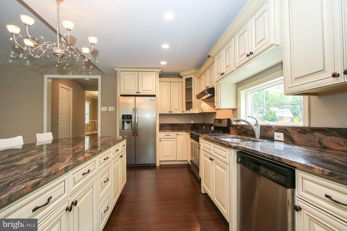 5612 Greentree Road Bethesda, MD 20817 - Photo 14 of 28 a kitchen with stainless steel appliances granite countertop a sink and cabinets