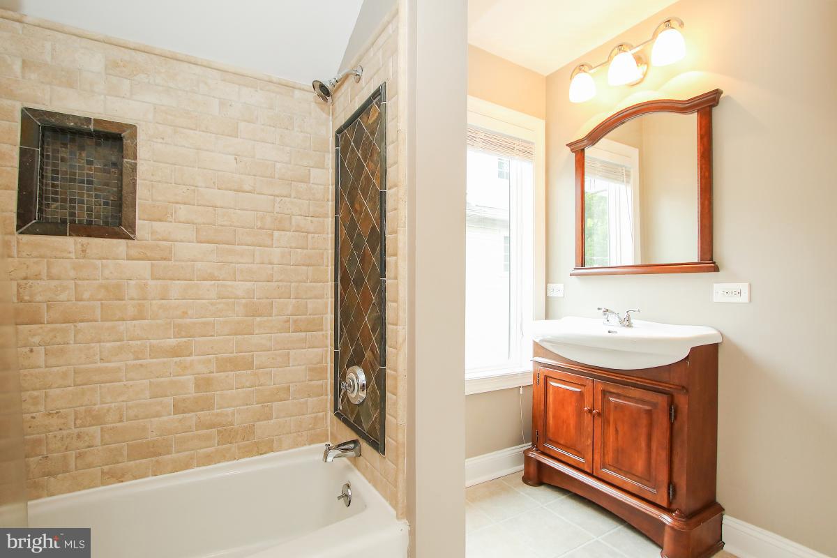 5612 Greentree Road Bethesda, MD 20817 - Photo 18 of 28 a bathroom with a sink a bathtub and a shower