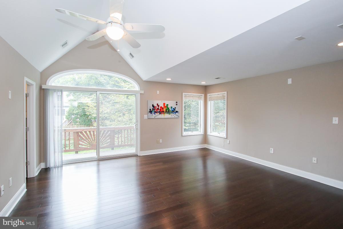 5612 Greentree Road Bethesda, MD 20817 - Photo 19 of 28 a view of an empty room with wooden floor and a window
