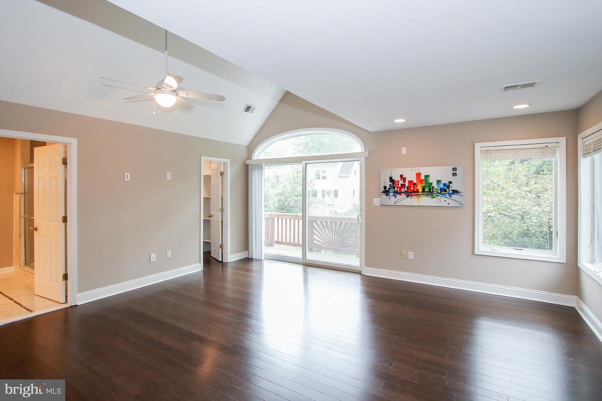 5612 Greentree Road Bethesda, MD 20817 - Photo 21 of 28 an empty room with wooden floor and windows