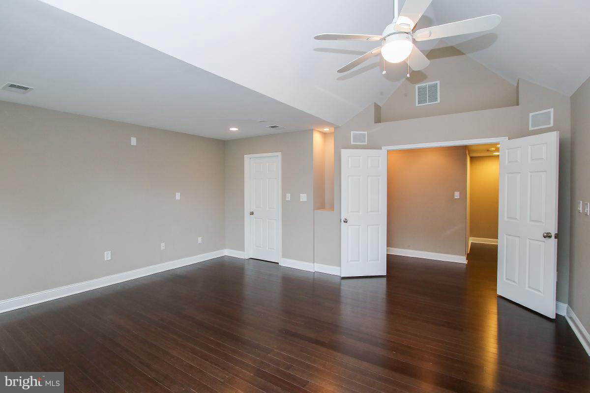 5612 Greentree Road Bethesda, MD 20817 - Photo 23 of 28 a view of an empty room with a window and wooden floor