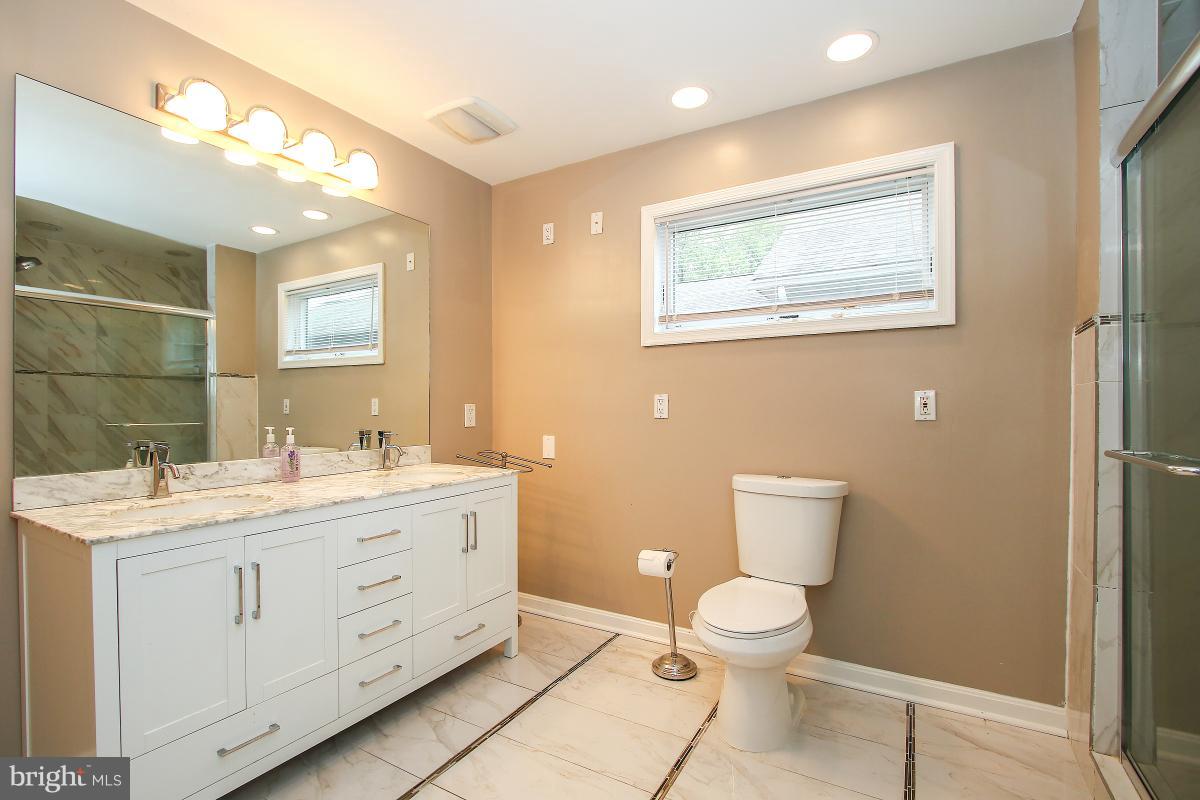 5612 Greentree Road Bethesda, MD 20817 - Photo 24 of 28 a bathroom with a toilet sink and mirror