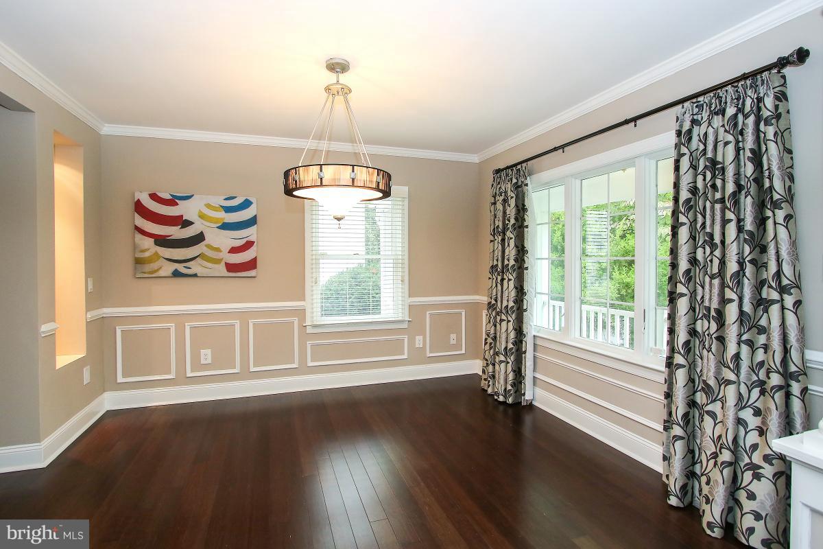 5612 Greentree Road Bethesda, MD 20817 - Photo 5 of 28 a view of an empty room with wooden floor and a window