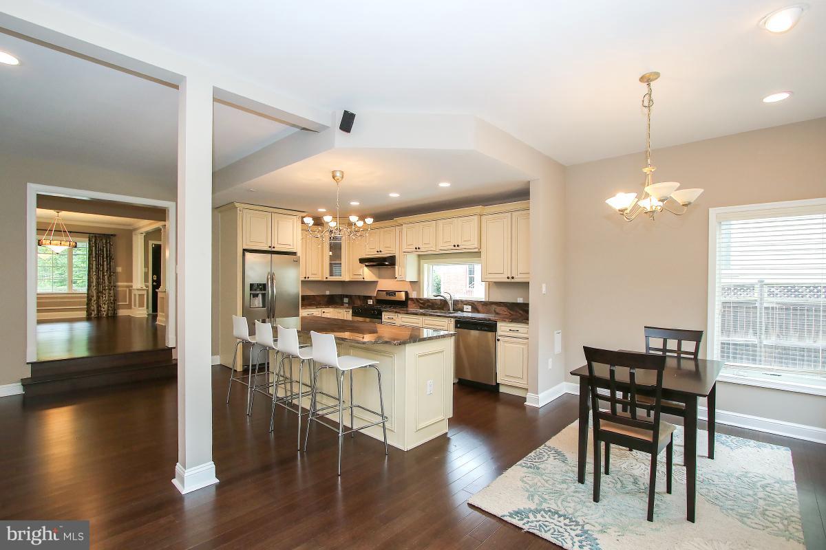 5612 Greentree Road Bethesda, MD 20817 - Photo 9 of 28 a kitchen with a dining table chairs and wooden floor