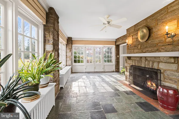 a view of an empty room with a fireplace and a window