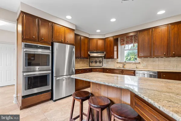 a view of a kitchen with white cabinets