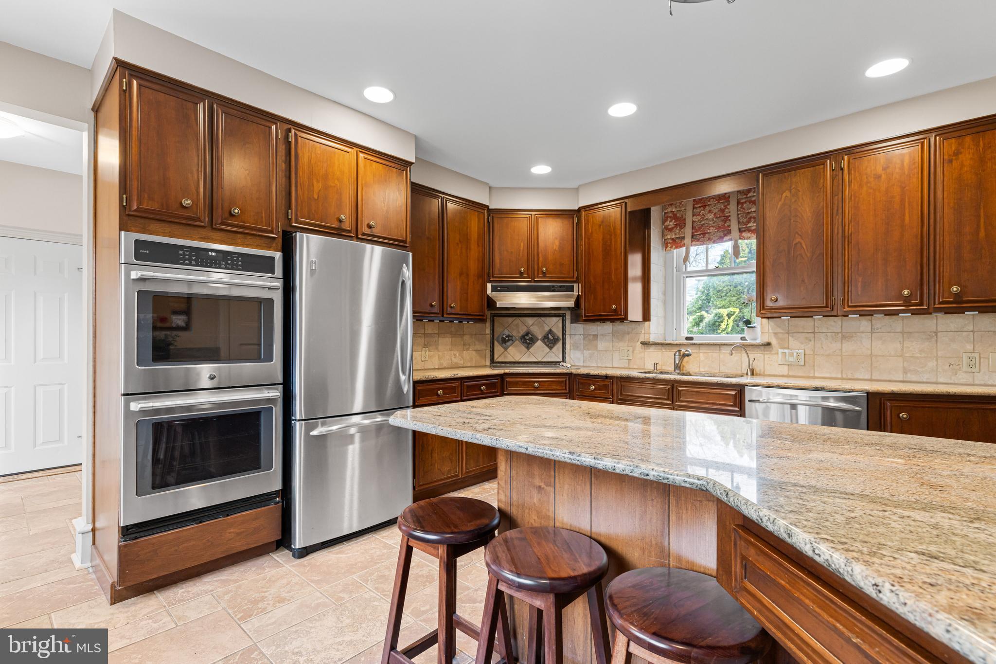 764 Glen Road Jenkintown, PA 19046 - Photo 18 of 57 a kitchen with granite countertop stainless steel appliances and wooden cabinets