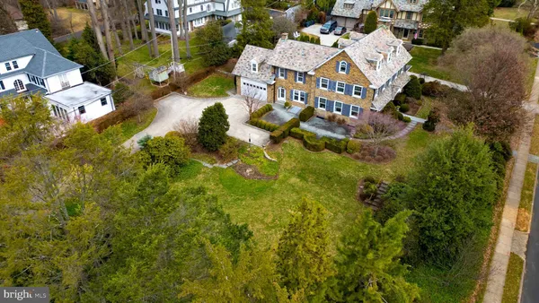 an aerial view of residential houses with outdoor space and trees