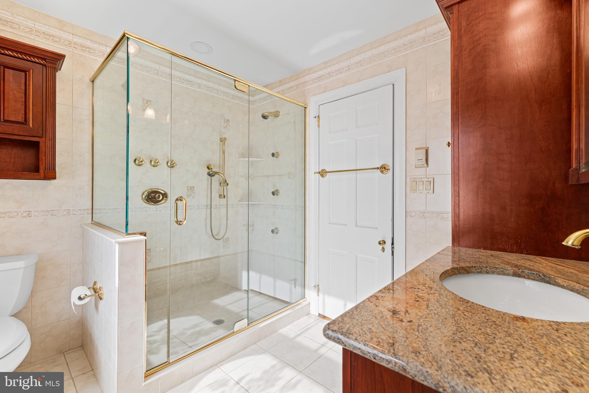 764 Glen Road Jenkintown, PA 19046 - Photo 25 of 57 a bathroom with a granite countertop sink mirror and shower
