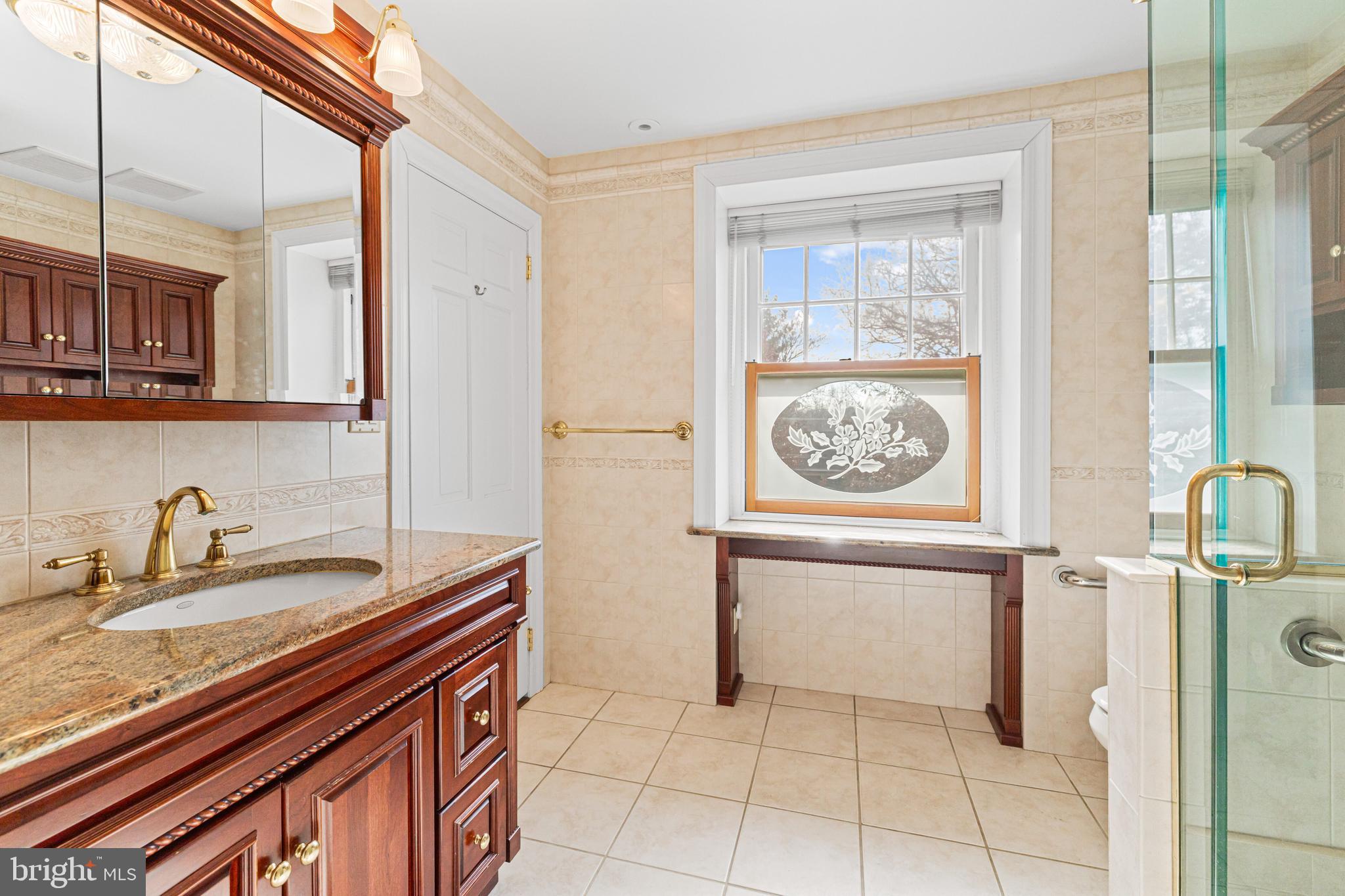 764 Glen Road Jenkintown, PA 19046 - Photo 26 of 57 a bathroom with a sink a vanity and a window