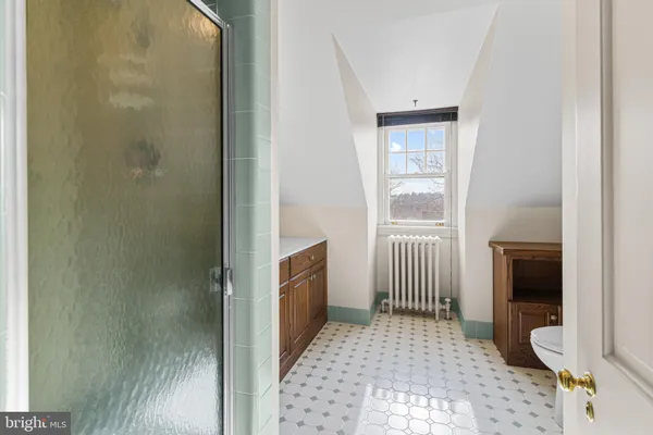 a bedroom with two beds and a window