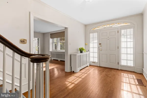 a view of an entryway with wooden floor and windows