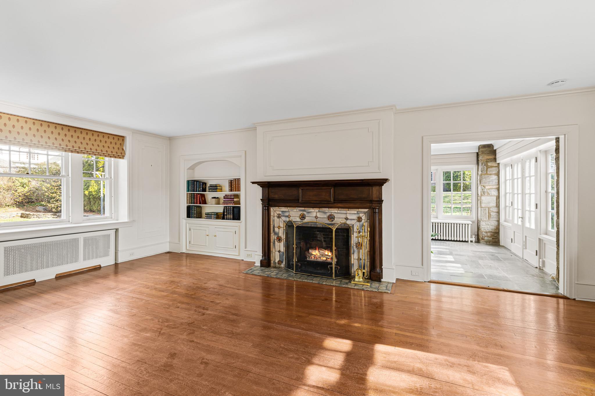 764 Glen Road Jenkintown, PA 19046 - Photo 7 of 57 an empty room with fireplace wooden floor and windows