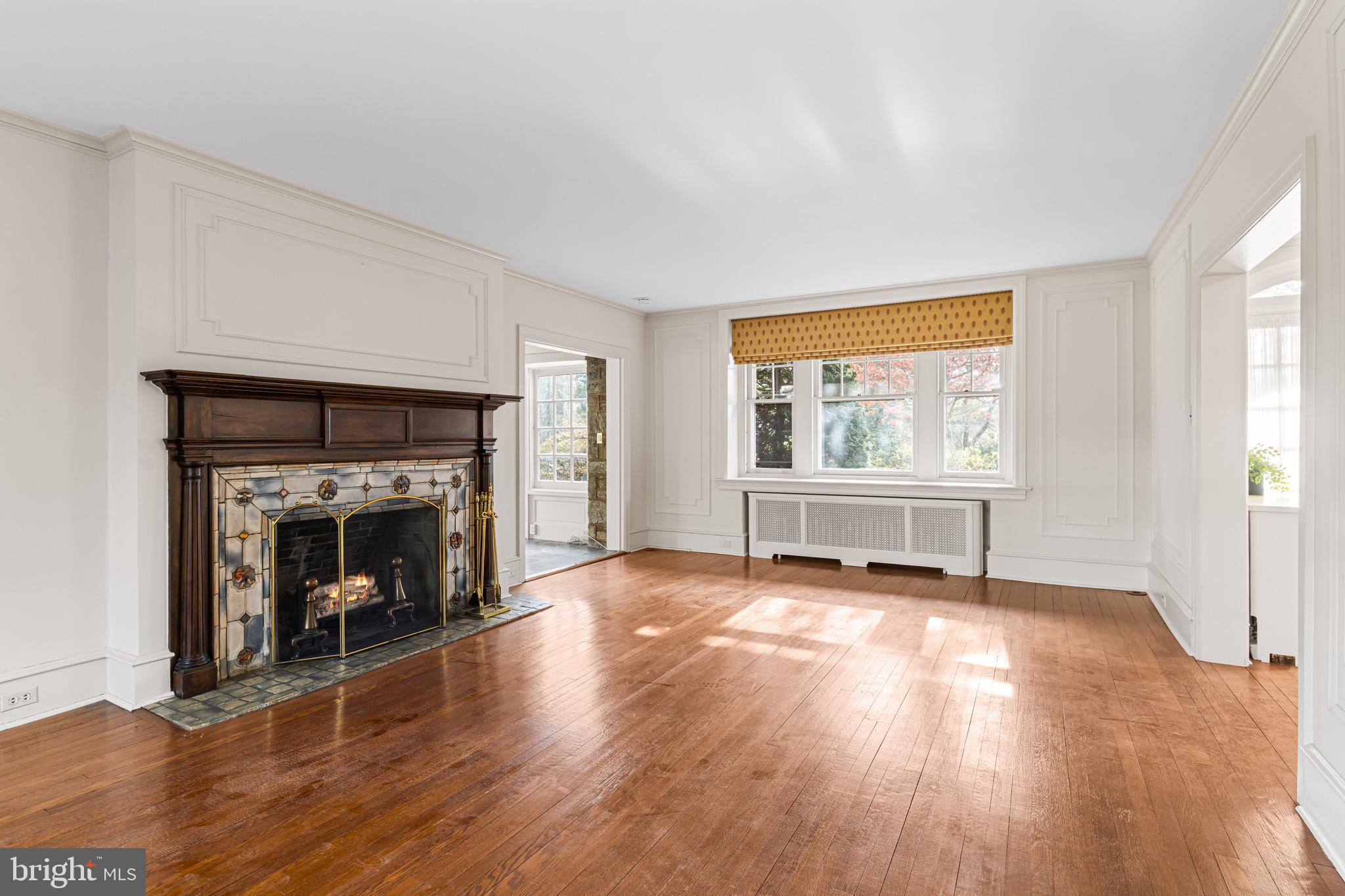 764 Glen Road Jenkintown, PA 19046 - Photo 8 of 57 an empty room with wooden floor fireplace and windows