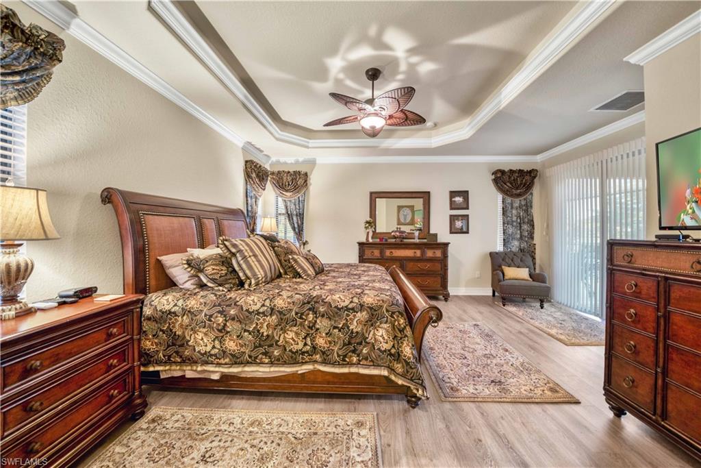9446 Piacere Way Naples, FL 34113 - Photo 15 of 23 a bedroom with a bed and wooden floor