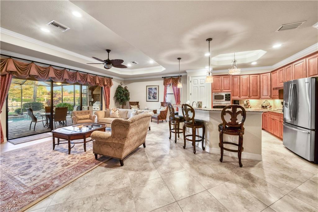9446 Piacere Way Naples, FL 34113 - Photo 9 of 23 a living room with lots of furniture and a large window