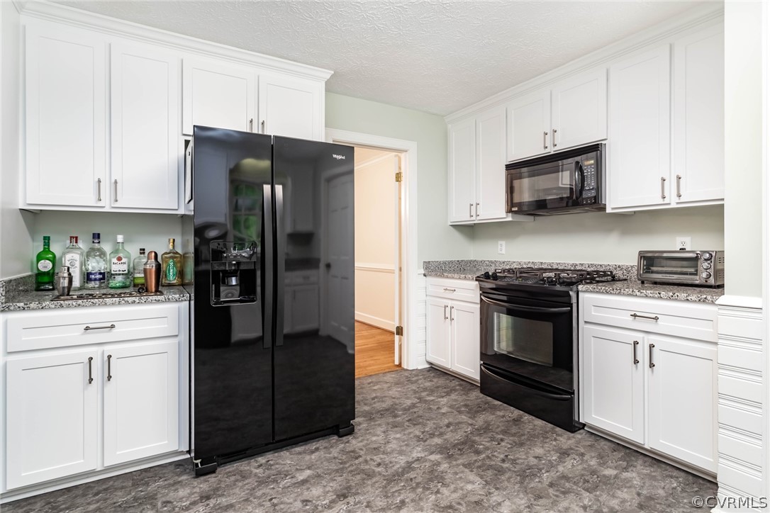 6 Staples Road Williamsburg, VA 23185 - Photo 14 of 37 a kitchen with stainless steel appliances granite countertop a refrigerator stove and white cabinets