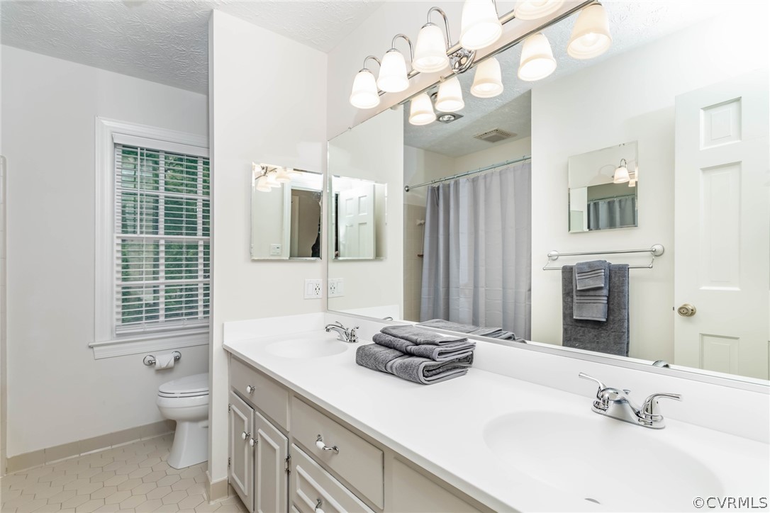 6 Staples Road Williamsburg, VA 23185 - Photo 24 of 37 a bathroom with a sink double vanity granite and a toilet