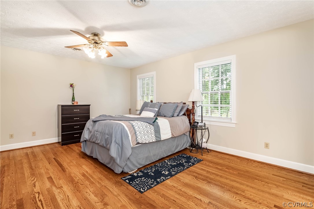 6 Staples Road Williamsburg, VA 23185 - Photo 26 of 37 a bedroom with a bed and wooden floor