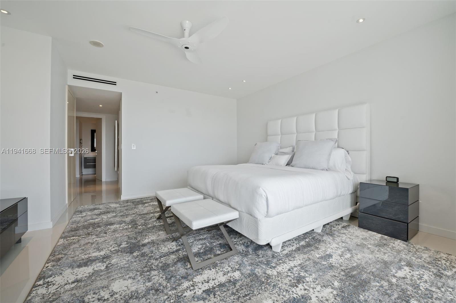 9601 Collins Avenue, Unit 908 Bal Harbour, FL 33154 - Photo 11 of 29 a bedroom with a bed and a television