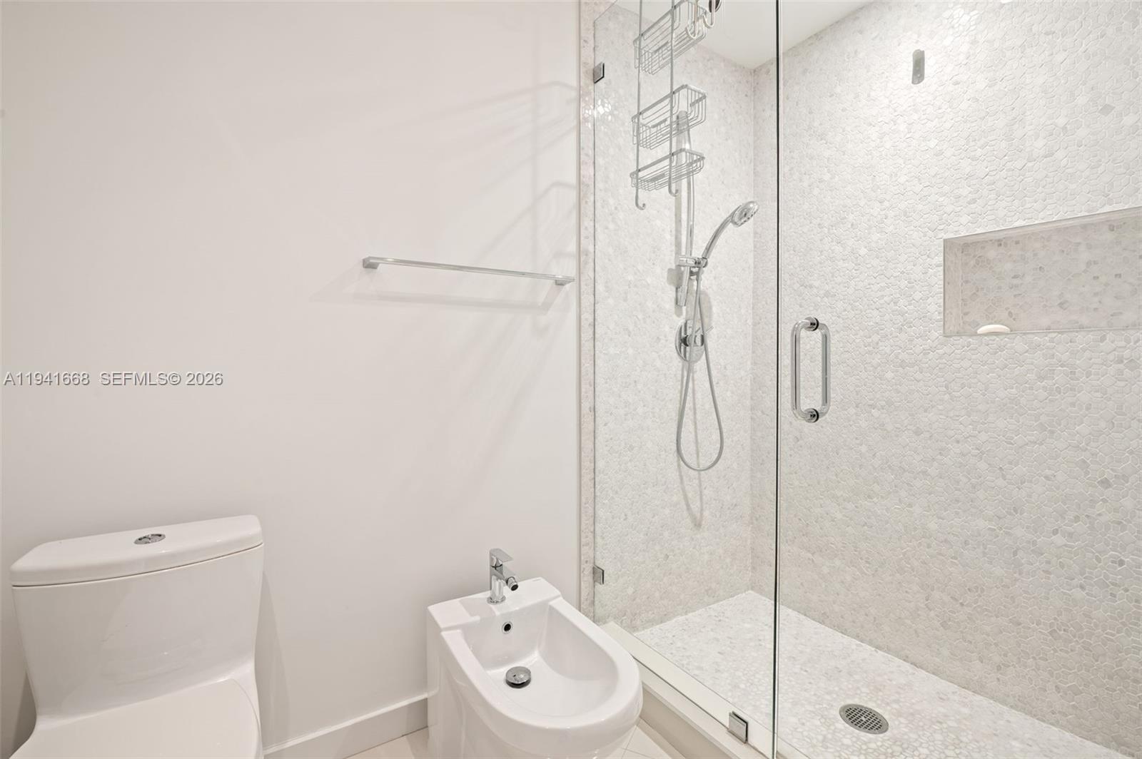 9601 Collins Avenue, Unit 908 Bal Harbour, FL 33154 - Photo 17 of 29 a bathroom with a shower bathtub and a toilet