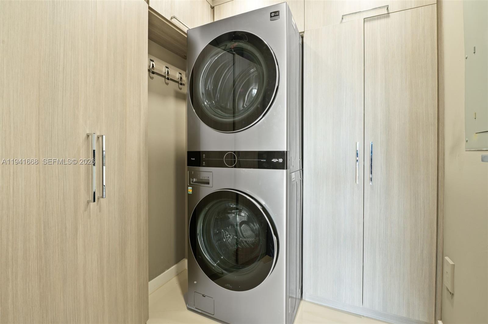 9601 Collins Avenue, Unit 908 Bal Harbour, FL 33154 - Photo 23 of 29 a utility room with dryer and washer