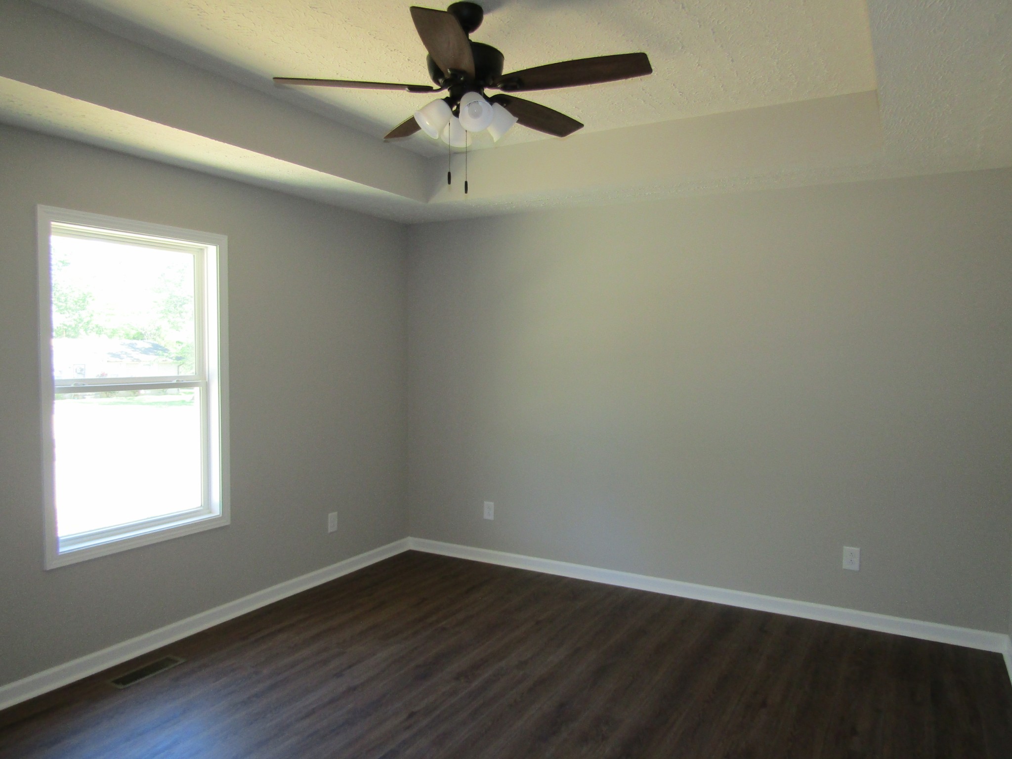 470 Crescent Factory Road Lawrenceburg, TN 38464 - Photo 9 of 15 an empty room with wooden floor fan and windows