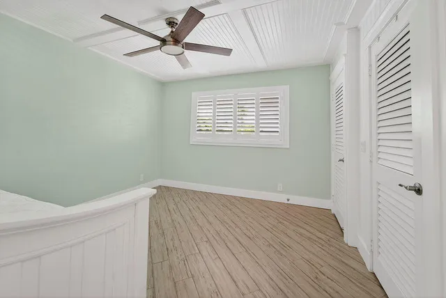 a bathroom with a granite countertop sink a mirror and a toilet
