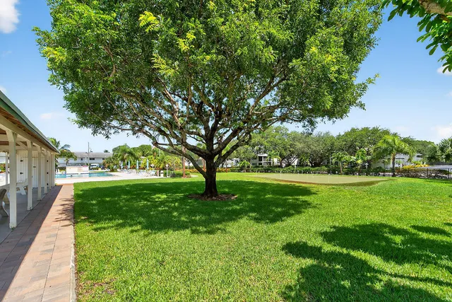 a living room with furniture a dining table and a bookshelf